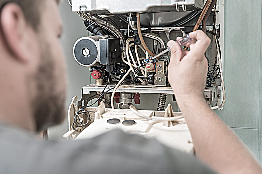 Repairman fixing gas furnace