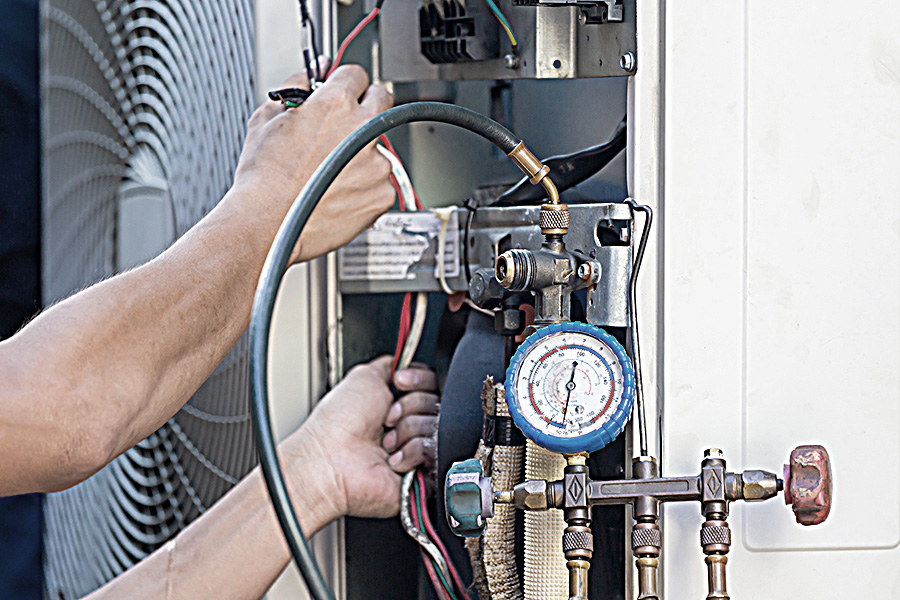 Technician checking leaking A/C unit