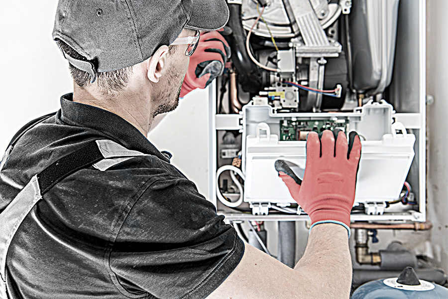 Technician fixing furnace issue
