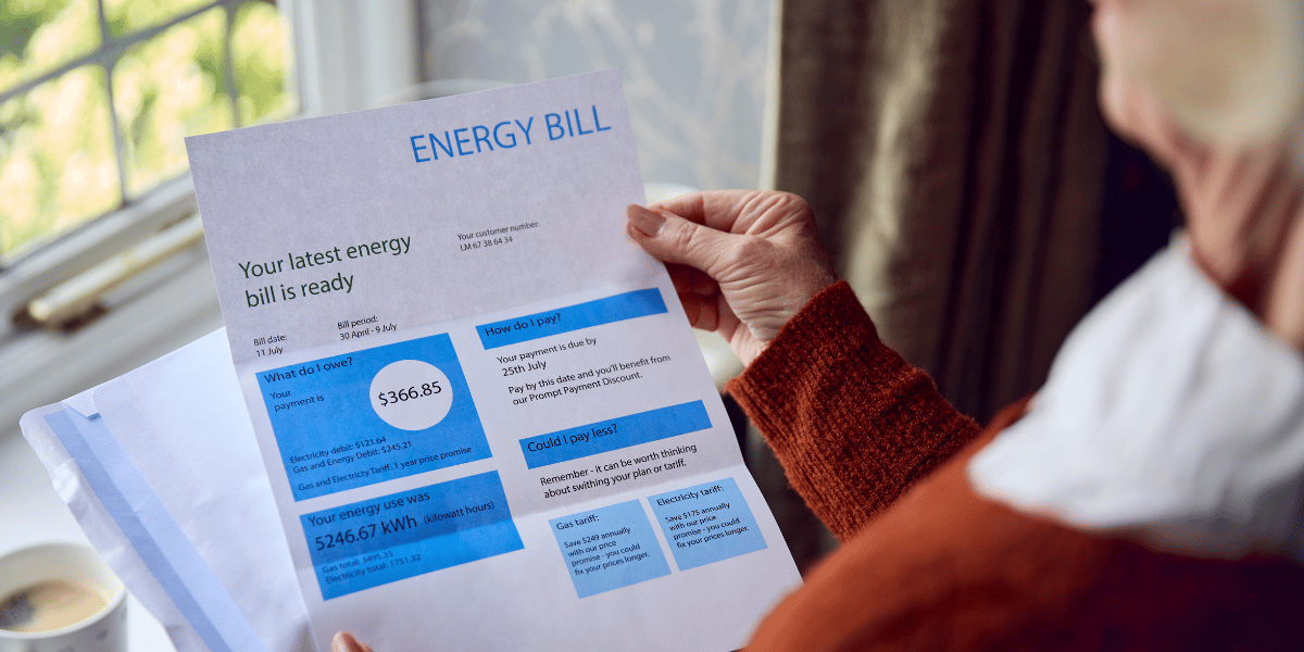 Elderly woman looking at a high energy bill